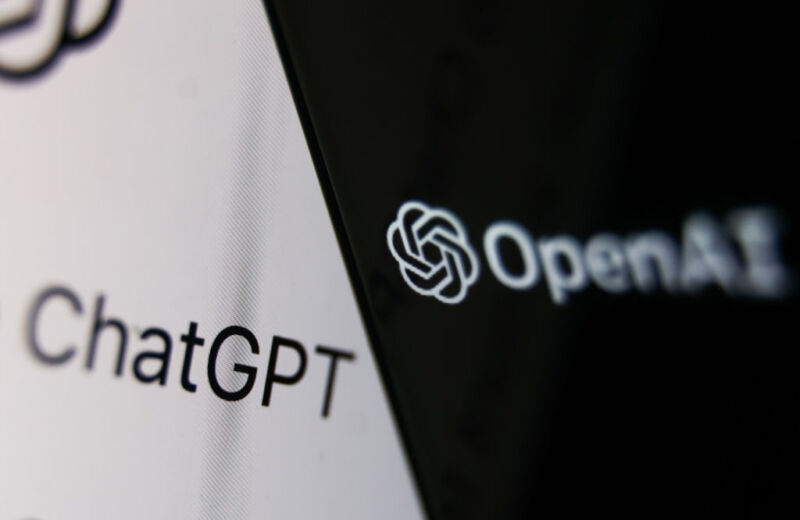 OpenAI logo displayed on a phone screen and ChatGPT website displayed on a laptop screen.