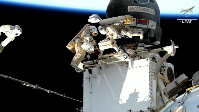 Cosmonauts Sergey Prokopyev and Dmitri Petelin conducting a spacewalk