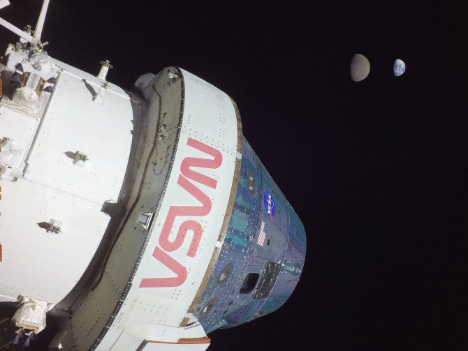 The Orion capsule from Artemis I, with the Moon and Earth in the background