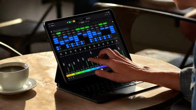 A user making adjustments to the software mixer in Logic Pro for iPad running on an iPad.