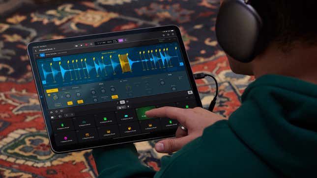 A user wearing headphones tapping on an effect in Logic Pro for the iPad running on an iPad.