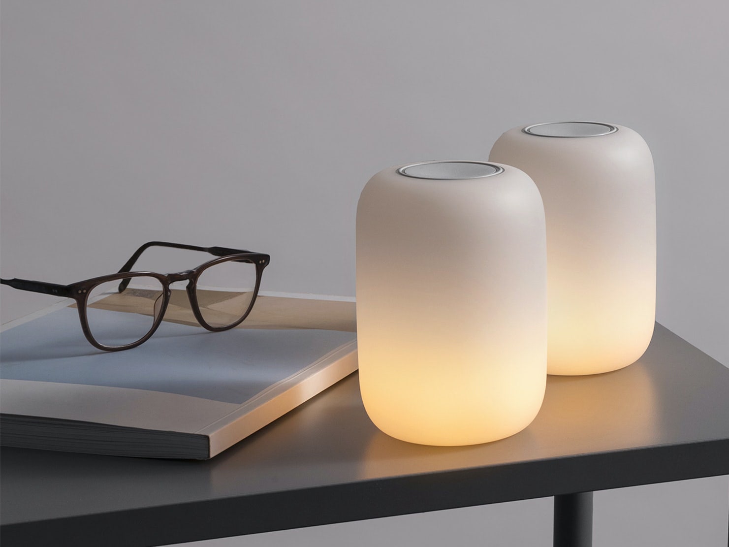 Casper Glow Lights sitting on table next to book and glasses
