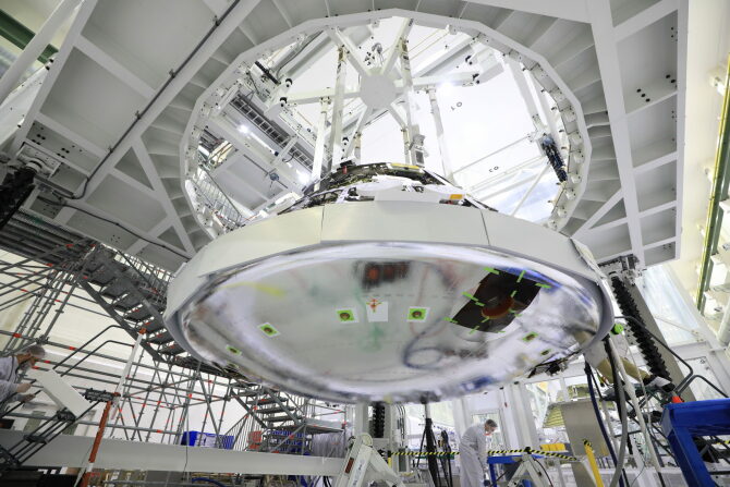Technicians install the heat shield for Orion inside the Neil Armstrong Operations and Checkout Building at NASA’s Kennedy Space Center in Florida.