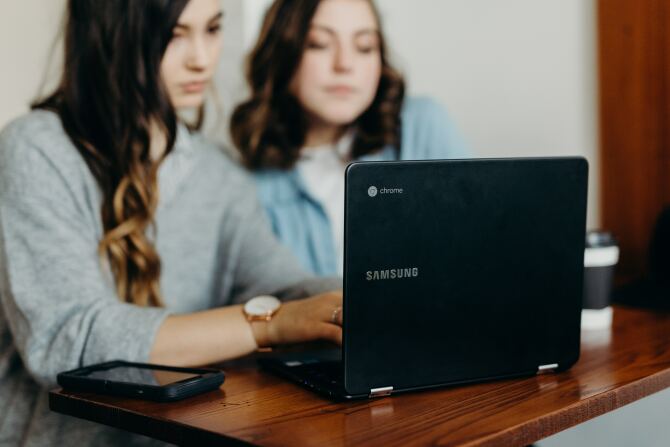 Two teenagers using a Samsung Chromebook.