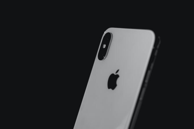 The back of an iPhone against a black background.